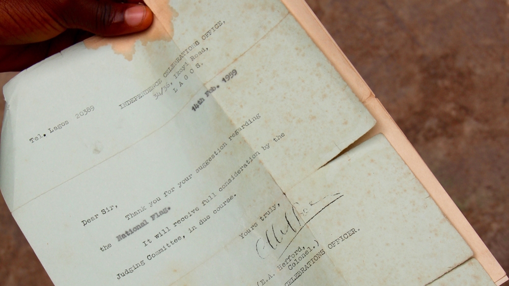 Michael Taiwo Akinkunmi still has the letter he received acknowledging his entry to the flag design competition [Femke van Zeijl/Al Jazeera]