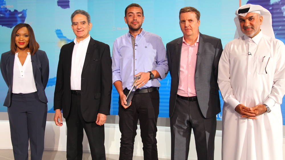 Baher Mohamed is given the Royal Television Society award he won with colleagues Mohamed Fahmy and Peter Greste while still in prison [Fadi Benni/Al Jazeera]