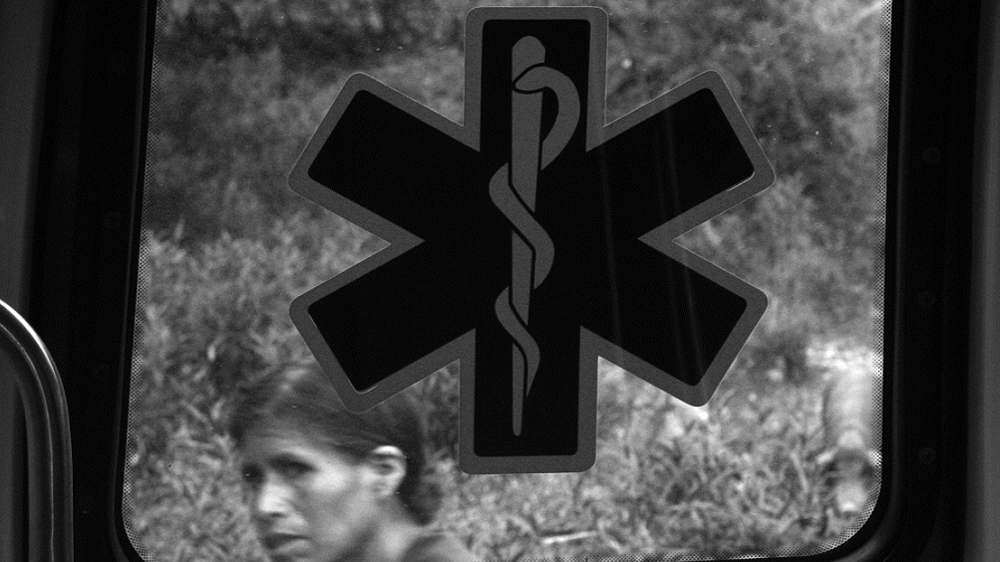 Maurilia's mother looks through the window of the ambulance [Prometeo Lucero]