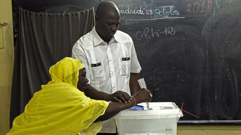 A woman casts her vote at a polling station during a presidential election in Abidjan