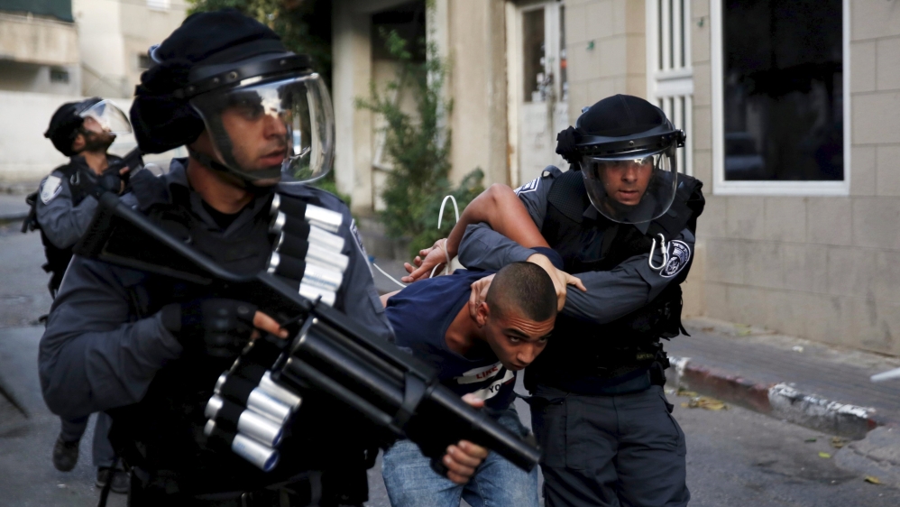 Israel police detain an Israeli Arab man during clashes in Nazareth at northern Israel