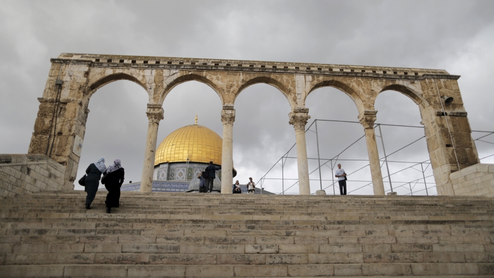 People walk near the Dome of the Rock in Jerusalem