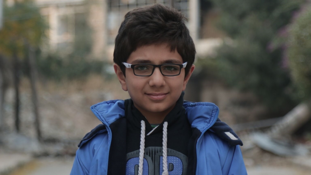 Eleven-year-old Yusuf Fathi doesn't go to school and isn't allowed to play outside in the street as his parents fear the bombs that killed his youngest brother [Zouhir Al Shimale/Al Jazeera]