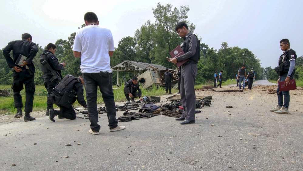 Military personnel and forensic experts inspect the site where soldiers were attacked by suspected Muslim militants at Sai Buri district in the troubled southern province of Pattani,