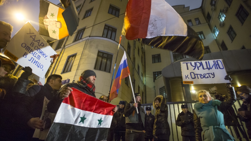 Protesters hold Russian and Syrian national flags and posters reading ''Turkey to account!'' and ''Stab in the back - a response in the face!'' during a picket at the Turkish Embassy in Moscow, Russia [AP