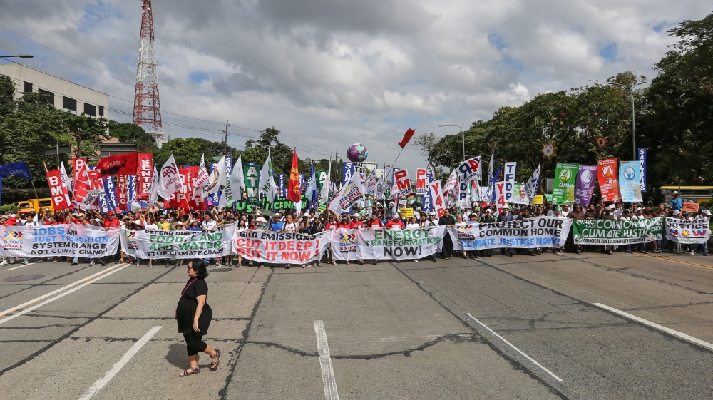 
A Filipino woman walks past demonstrators holding banners during the Global Climate March in Quezon City, northeast of Manila, Philippines [EPA] People hold banners during the Global Climate March in Geneva [EPA] People hold banners during the Global Climate March in Geneva [EPA] People hold banners during the Global Climate March in Geneva [EPA]People walk past the art-work 'Where the Tides ebb and flow' by Argentinian artist Pedro Marzorati installed in a pond at the Montsouris park ahead of the COP21 World Climate Summit [Reuters]
Indian school children arrive to present a symbolic globe to the Indian Minister of State for Environment ahead of the COP21 climate change summit in Paris [EPA] A polar bear-costumed person gestures during 'Earth Parade 2015' in Tokyo [EPA] Police stand around a climate change protester who had been blocking train tracks in front a train which was supposed to take the German environment minister to the climate summit in Paris [EPA]
Employees put the final touches during the installation of the exhibition 'Paris de L'Avenir,' a showcase for tangible climate solutions in the context of COP21, in front of Paris City Hall [Reuters]