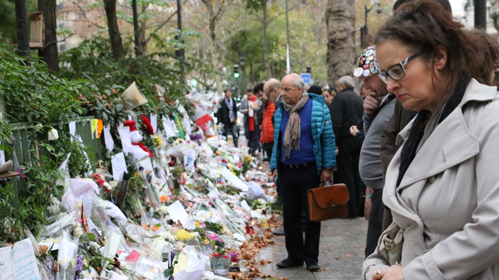 A wall of flowers and tributes opposite the Bataclan [Kyle G. Brown/Al Jazeera] 