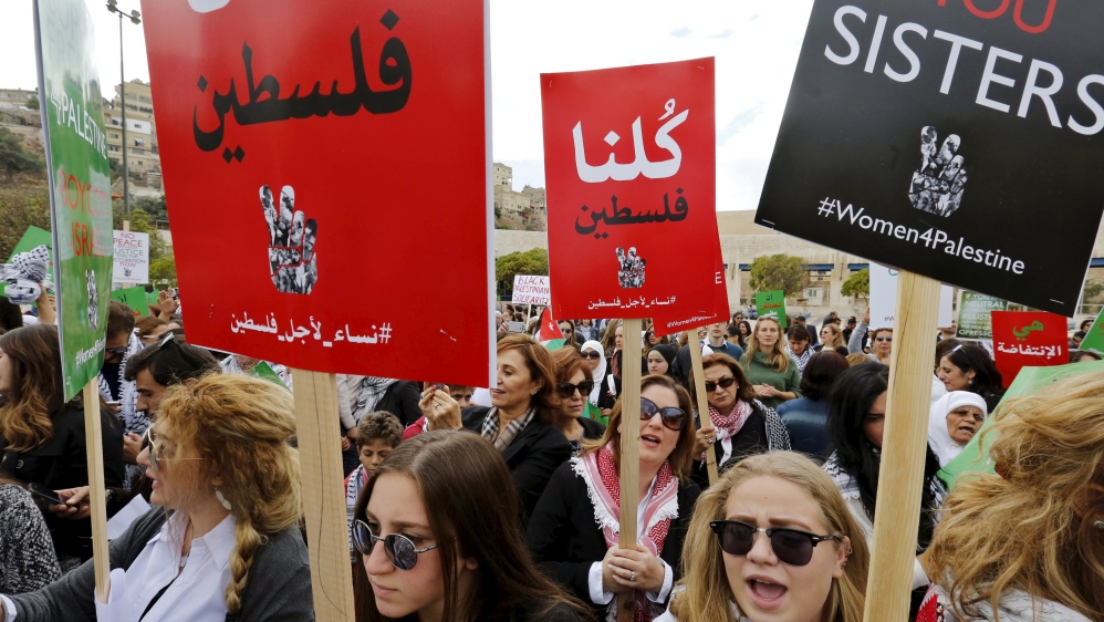 Women protesters carry banners as they chant slogans during a protest to express solidarity with Palestinians and against the escalation of Israeli-Palestinian violence, in Amman, Jordan