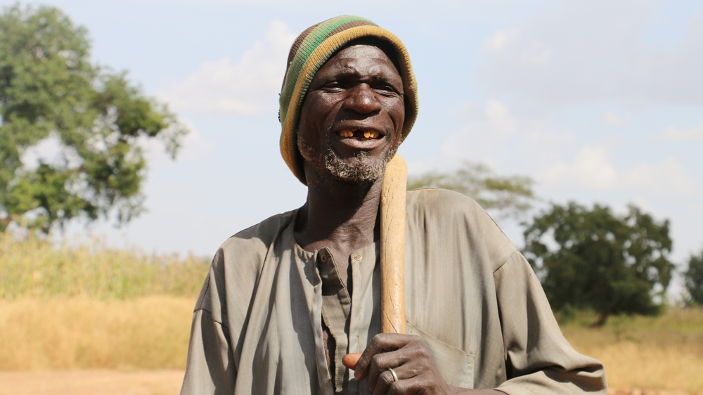“Now we are able to catch water and keep moisture for longer,” says Wobi Kiankiandou, who has embraced agro-ecological techniques [Arwa Aburawa/Al Jazeera]