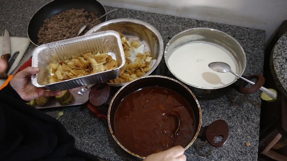 Initiatives like Hawa Kitchen cater to Syrian refugees - but the Sudanese are also developing a taste for Syrian food [Ashraf Shazly/AFP]