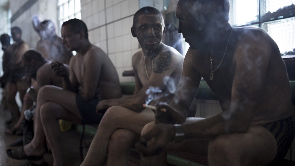 Miners smoke at the end of their shift in a legal mine in Donetsk. Working in a legal mine means taking fewer risks, better working conditions, regular pay and, most importantly, getting a pension. But, it is hard for young miners to find a job in a legal mine, particularly if they have a criminal record or do not have the right connections. [Janos Chiala and Tali Mayer/Al Jazeera] 