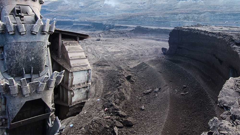 The hole made by a bucket wheel excavator shows the layers of lignite that are removed from the Sibovc Southwest coal mine [Valerie Plesch/Al Jazeera]