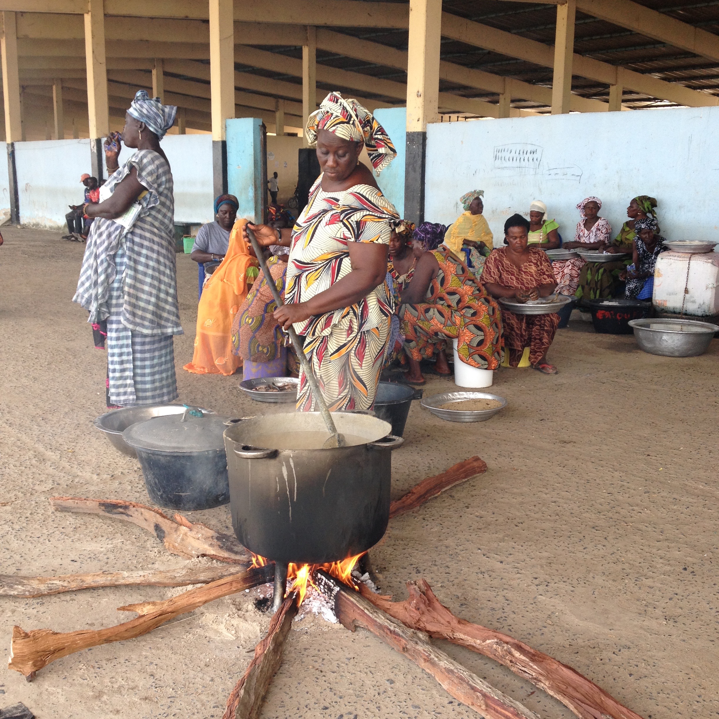Women of Joal prepare sweet millet porridge as an offering to the sea, as part of the ceremony in which the townfolk asked the depleted Atlantic Ocean for more fish [Anna Badkhen/Al Jazeera]