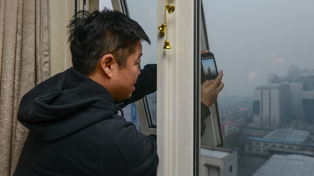 Zou Yi's photos of pollution in Beijing have stunned many on the internet [Aaron Berkovich/Al Jazeera] 