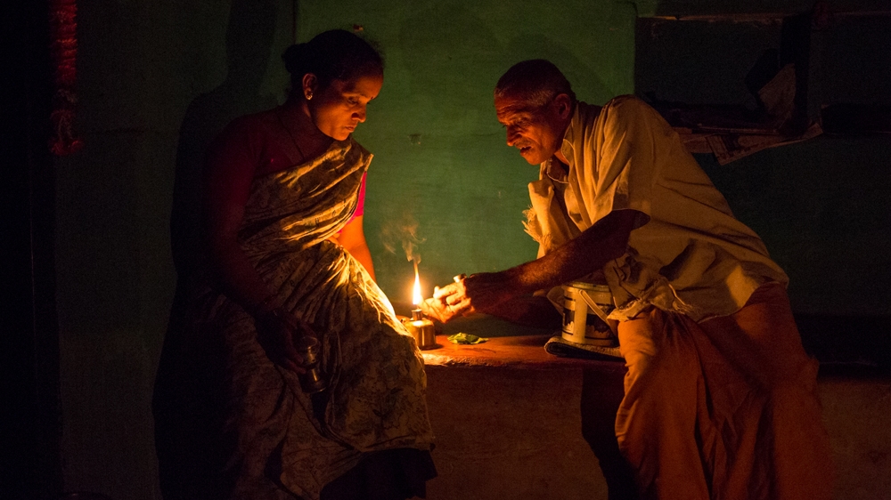 In the evenings Neelkumar and Rajmati sit on their veranda eating areca nut [Vivek Muthuramalingam/Al Jazeera]
