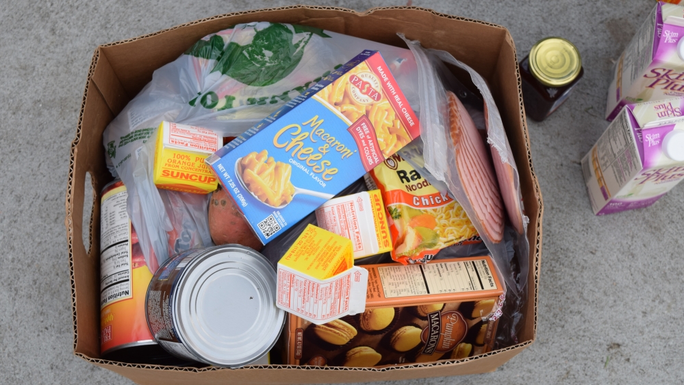 In prison, Doroshow helped inmates work with what they had to make tastier meals. At the food pantry she does the same, advising people on what they can cook [Lene Bech Sillesen/Al Jazeera]