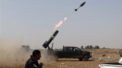 Iraqi security forces launch a rocket against ISIL positions in Tikrit last year [AP]