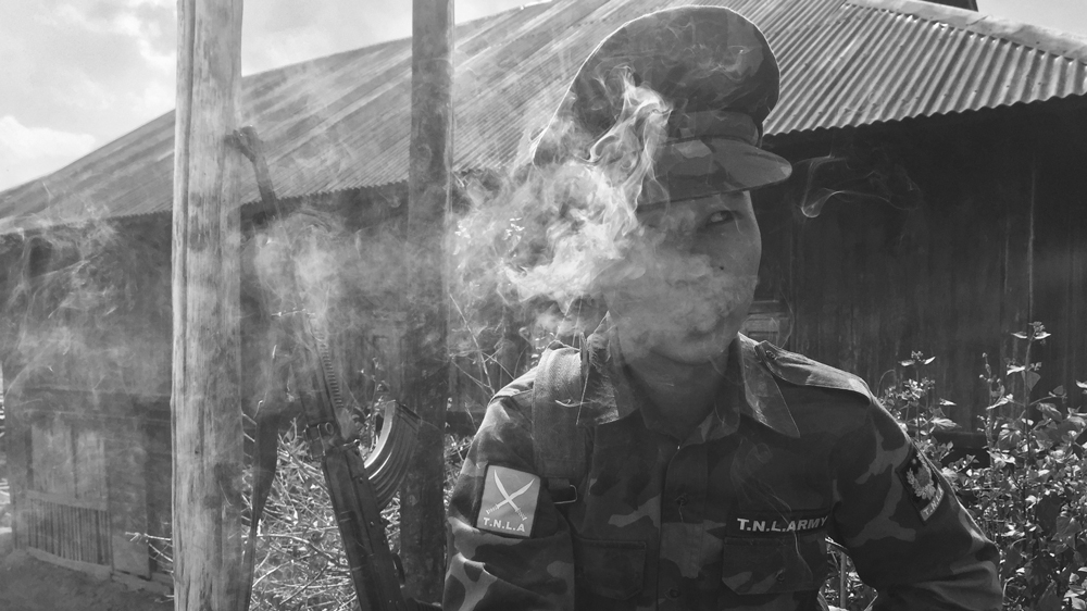 A TNLA fighter enjoys some downtime [Wayne Hay/Al Jazeera]