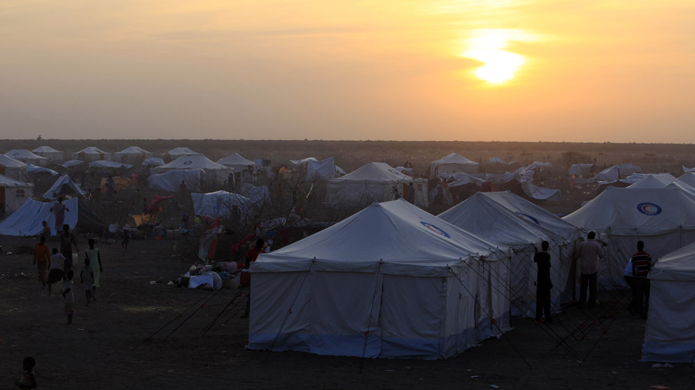 Refugees wait inside camp Kilo 10 on the Sudan border, in White Nile State, after arriving from the Malakal and al-Rank war zone inside South Sudan [Mohamed Nureldin Abdallah/Reuters]