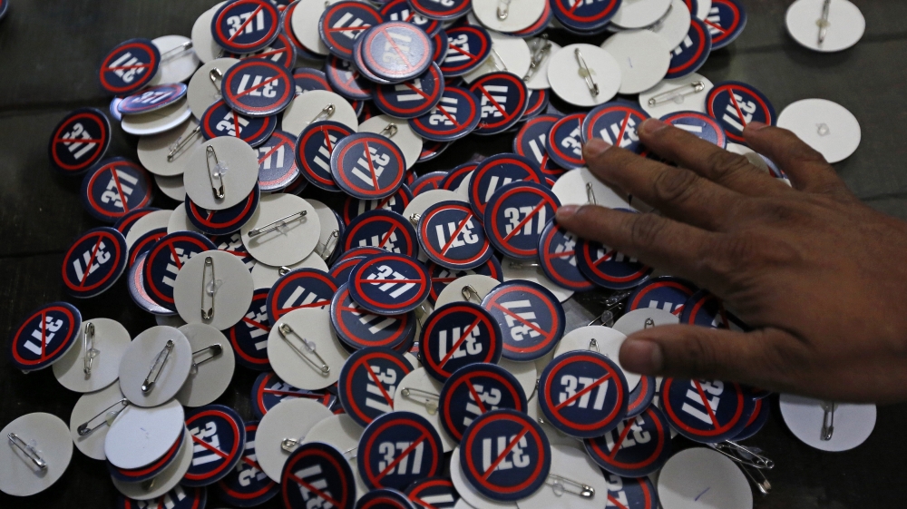 A gay rights activist distributes badges during a gathering in Mumbai
