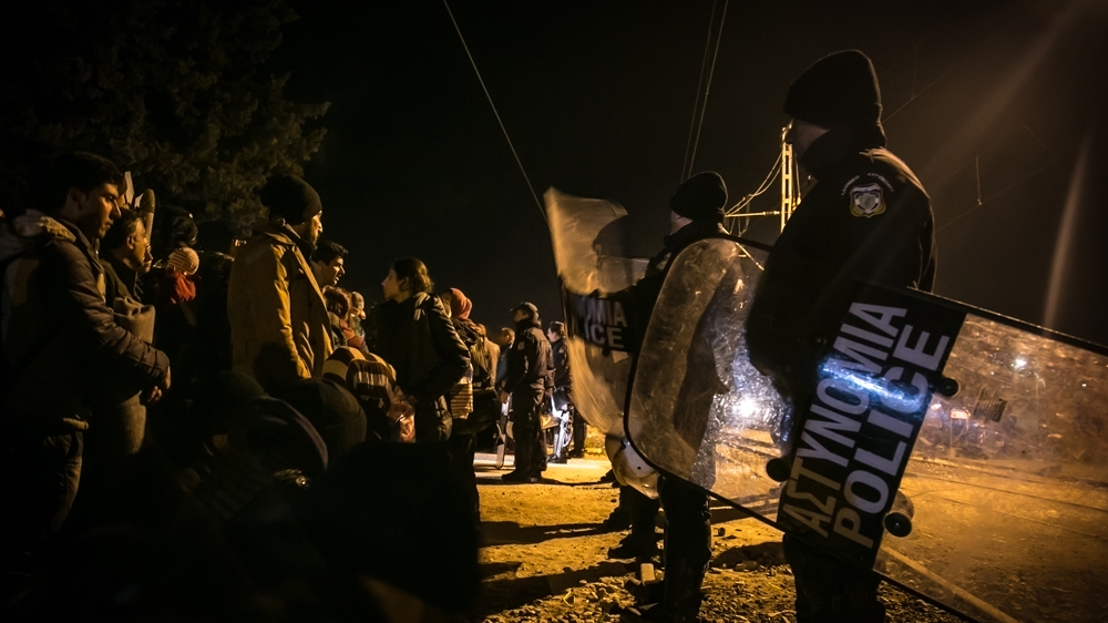 Police block refugees from entering the camp of Idomeni after they walked from the petrol station of Polikastro [Nicola Zolin/Al Jazeera] 