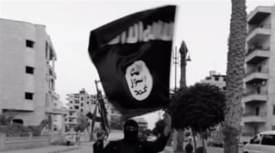 An ISIL fighter waves an ISIL flag in Raqqa, Syria [Reuters]