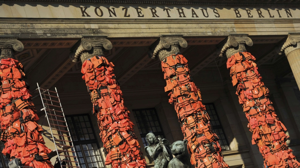 Workers bulid up an instalation by Chinese artist Ai Weiwei with life jackets left by migrants on Greek beaches on columns at the Schauspielhaus concert hall in Berlin
