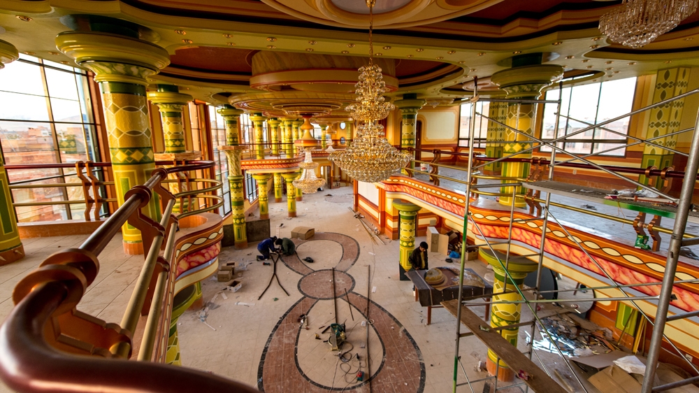 A typical 'chalet' consists of a ground floor featuring a covered car park, a second floor with a grand ballroom, an upper floor with apartments and a roof with a replica of a traditional El Alto brick house [Javier Sauras/Al Jazeera] 