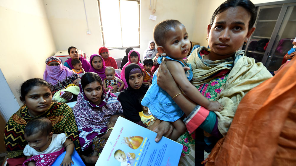 Anxious mothers wait, hoping their children will be selected to undergo life-saving heart surgery in Dhaka, Bangladesh [Owen Humphreys/Al Jazeera]