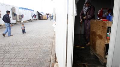 In this 2012 photo, Syrian refugee Havla Araby cleans her family container in a refugee camp on the Turkish-Syrian border in Kilis province, southern Turkey [Reuters]