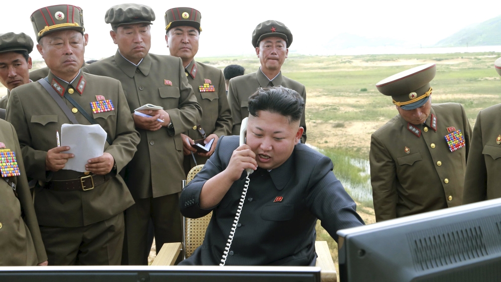 North Korean leader Kim Jung Un guides the test fire of a tactical rocket in this undated file photo