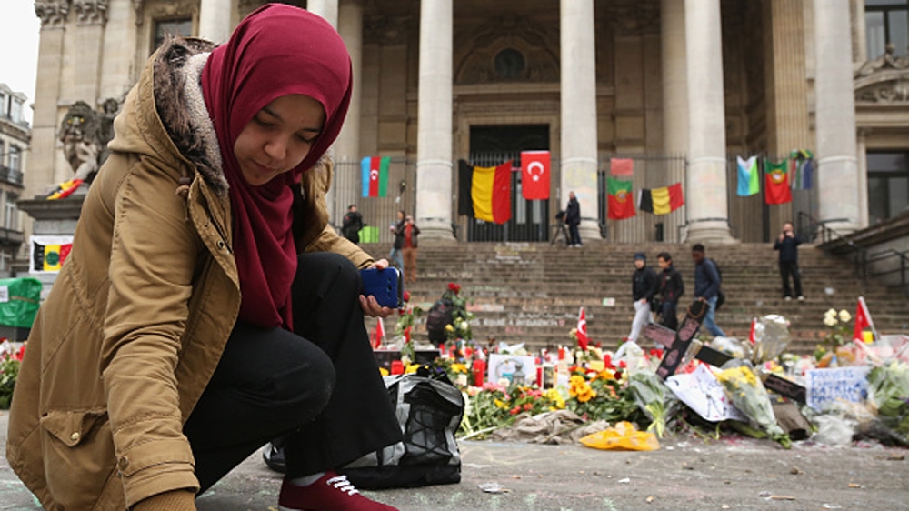 A visitor writes a message in chalk at a memorial at Place de la Bourse in Brussels [Getty]