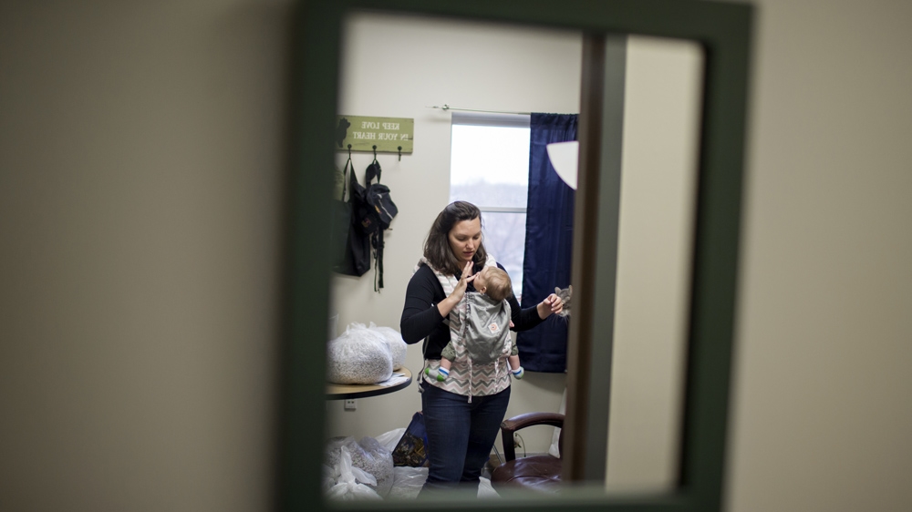 A typical day, Rebecca says, will see her bringing Zach to work for six to seven hours; he nurses, he naps, he plays in his Pack and Play [James Brosher/Al Jazeera] 