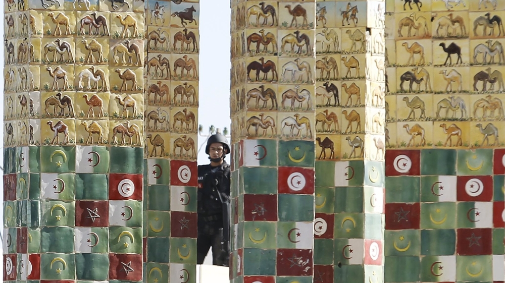 A Tunisian police officer stands guard near a police station after Monday''s attack by Islamic State militants on army and police barracks in the town of Ben Guerdan, Tunisia, near the Libyan border