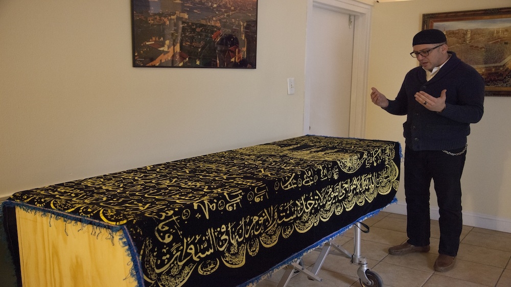 Kargi offers a private prayer for a young man from Dagestan before his body is taken to a cemetery in Queens, New York [Mir Ubaid/Al Jazeera]