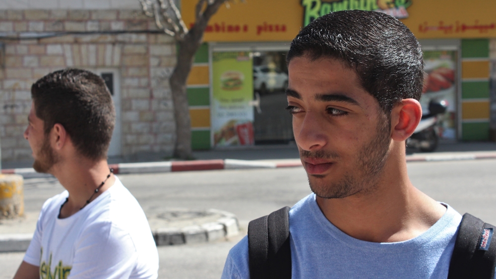 Palestinian Student Mohammed Saeed stands outside Beitunya boys' high school after his morning classes were cut short by the teachers' strike. [Mary Pelletier/Al Jazeera]