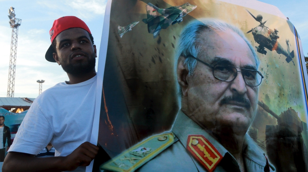 A man holds a picture of General Khalifa Haftar during a demonstration in support of the Libyan army under the leadership of General Khalifa in Benghazi
