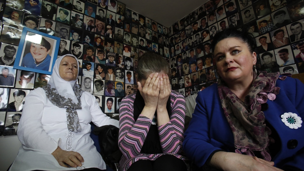 Bosnian Muslim women who lost family members in Srebrenica react as they watch a TV broadcast of the sentencing of Radovan Karadzic [Amel Emric/AP]