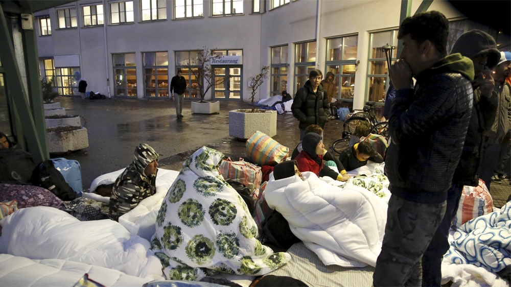 Refugees sleep outside the entrance of the Swedish Migration Agency's arrival centre for asylum seekers in Malmo. Property prices have shot up in Sweden [Stig-Ake Jonsson/TT News/Reuters] 