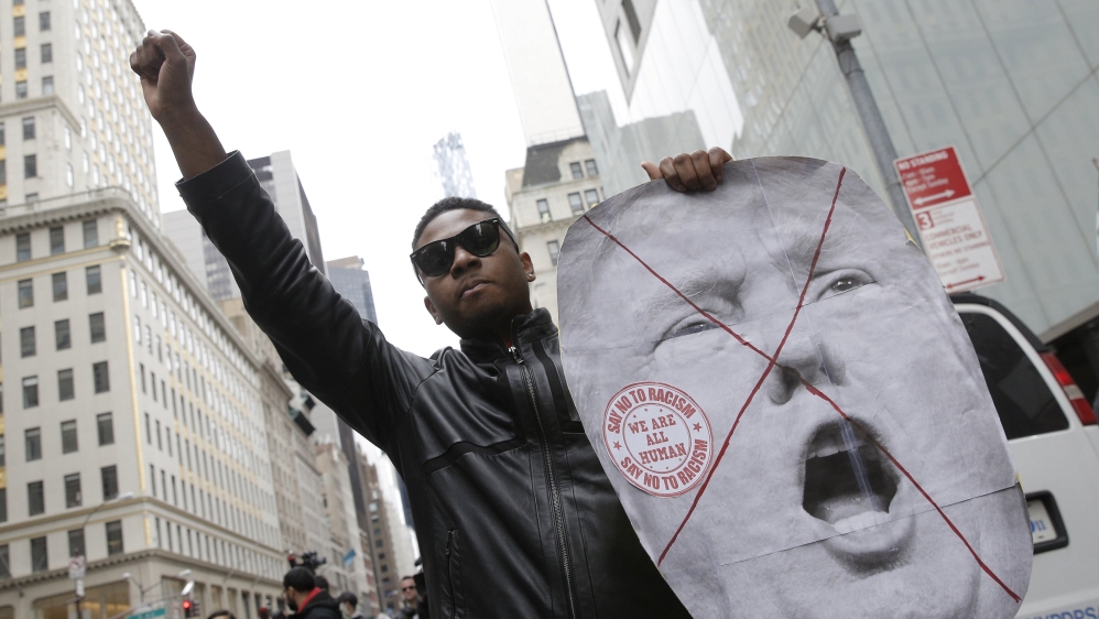 A demonstrator reacts during a protest against Trump, outside the Trump Tower building in Midtown Manhattan in New York [Reuters]