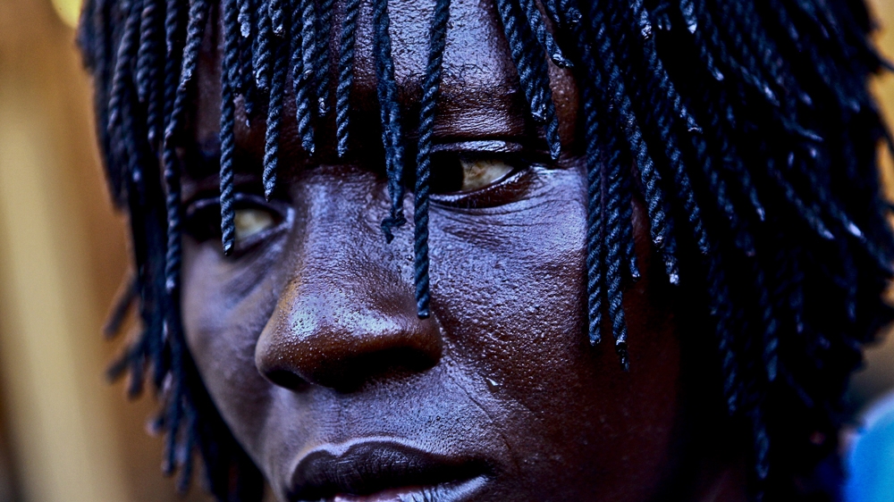 Morine Nakilyowa says her four children have inspired her to pursue her boxing career. 'I am a boxer because of mainly three reasons,' she says: 'Passion, to fend for family, and protect my children from this volatile environment' [Edward Echwalu/Al Jazeera] 