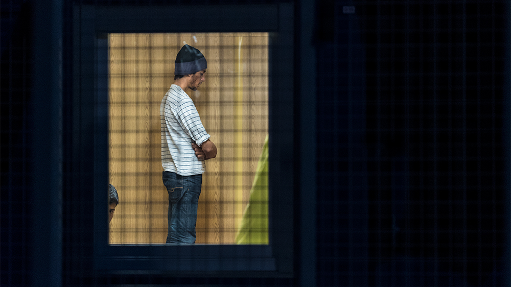 Refugees during evening prayer time in a transit centre on the Hungarian-Serbian border [Sorin Furcoi/Al Jazeera]