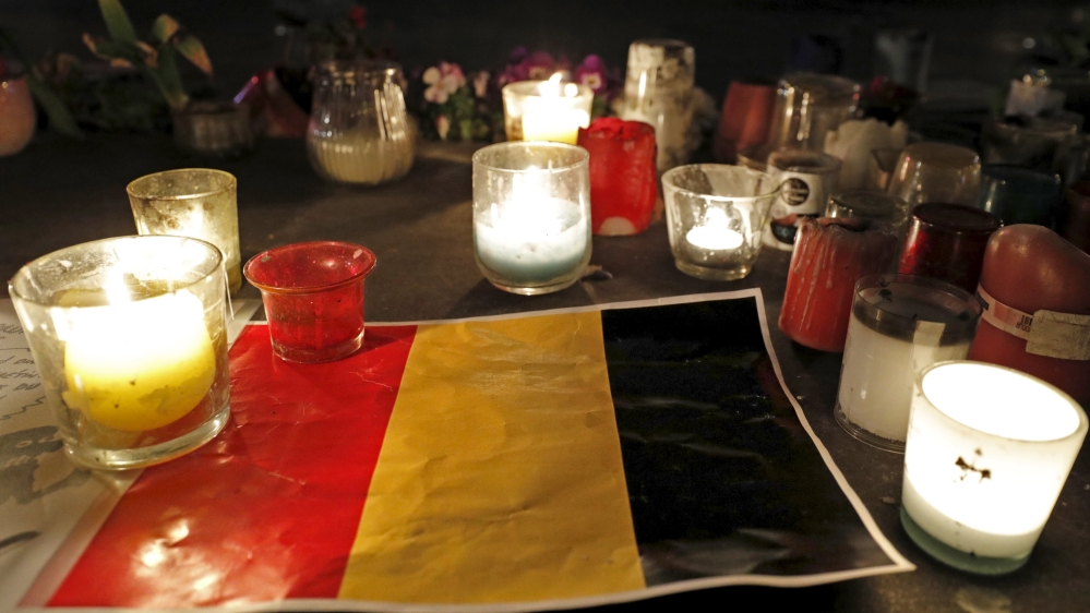 Candles are pictured around a Belgian flag on the Place de la Republique in Paris