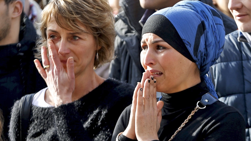 People pay tribute on Saturday to the victims of the attacks in Brussels. But a peace march scheduled on Sunday has been postponed due to security concerns [Reuters]