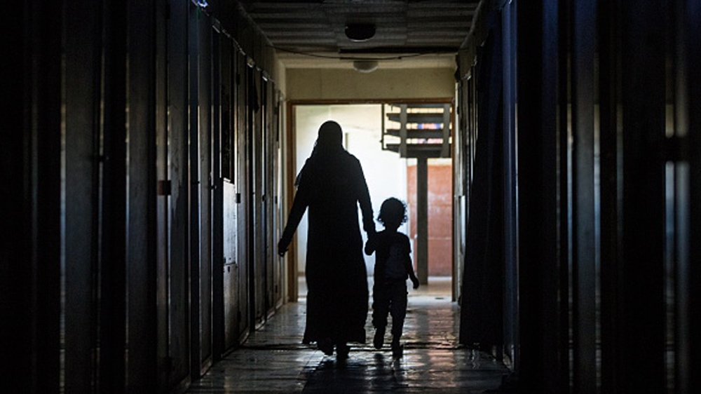 A Syrian woman with a kid at a camp for internally displaced persons near the city of Hama [Getty]