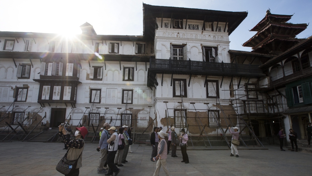 Japanese tourists visits the Kathmandu Durbar Square surrounded by supported wooden poles, Kathmandu, Nepal [EPA]