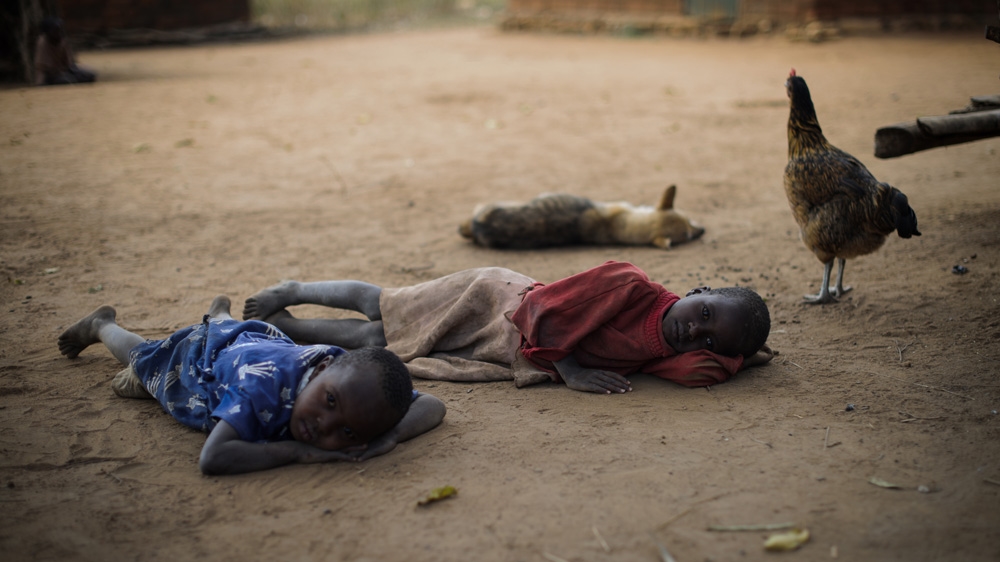 Kimweli Mbithuka and his wife, Naomi Nziula Kimweli, were travelling with their three children when they were stopped by colonial soldiers. The couple were separated from each other and never saw their children again. They took in several young women as daughters over the years, and subsequently have surrogate great-grandchildren [Phil Moore/Al Jazeera]