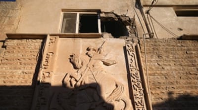The facade of St George's Church stands damaged from war in Telskuf, near the frontline with ISIL in northern Iraq [Getty]