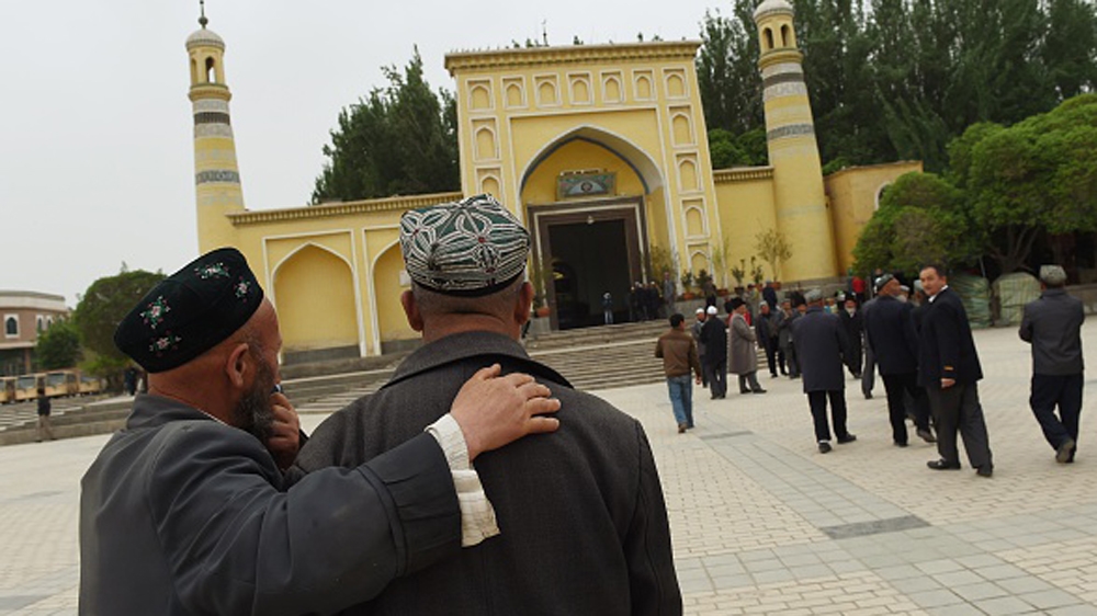 Uighur men making their way to the Id Kah mosque for afternoon prayers in Kashgar, in China''s western Xinjiang region [AFP]