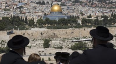 Ultra-Orthodox Jews walk at the ancient Jewish cemetery on the Mount of Olives in Jerusalem [EPA]